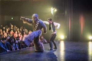 Dancers perform onstage dressed as Han Solo and Chewbacca